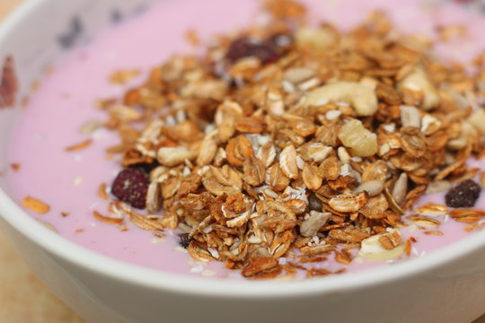 Healthy breakfast. Nuts, cereals, seeds, raisins, candied fruits and milk yogurt
