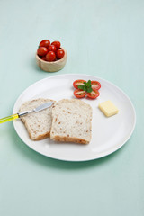slice bread with butter and cherry tomato