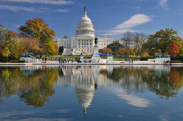 U.S. Capitol Building and its reflection over the pool in autumn foliage - Washington D.C. United States of America