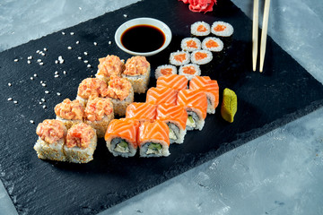 Set of traditional Japanese sushi - maki with salmon, california and spicy rolls. Top view