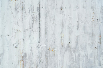 Galvanized sheet painted with white color. Empty white wall texture background. Peeling paint on white wall. Distorted striped gray galvanized sheet. Empty white and gray background for minimal life.