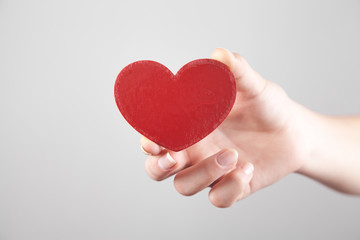 Girl hand showing red heart.
