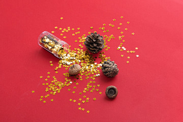 Vertical photo of golden star glitter on red background. Top view. Christmas background