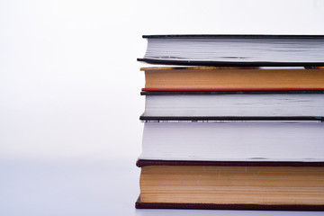 Stack of books on white background. Copy space
