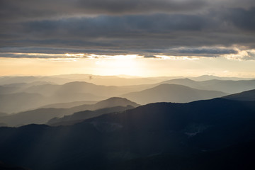 Obraz premium view of sunset above mountains peak
