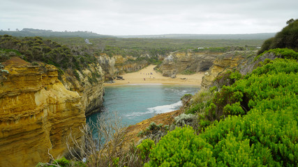 People on the beach at Loch Ard Gorge on the Great Ocean Road in Victoria, Australia