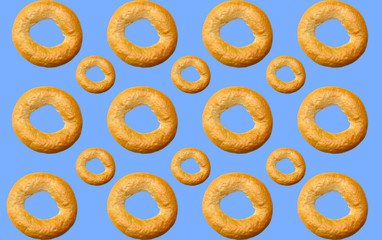 Pattern of delicious bagels on a blue background.