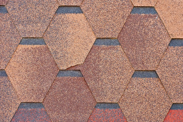 Flexible tile is made of fiberglass impregnated with bitumen. Texture of orange roof close up.