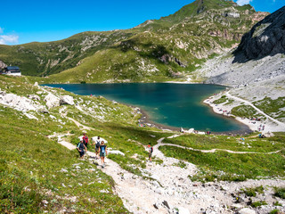 hikers near Volaia lake, Carnic Alps, Austria