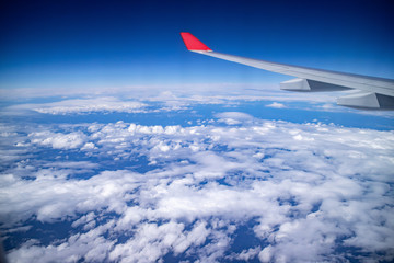 Aerial view during flight with clear blue sky and the cloud