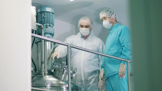 Biochemical reactor and two pharmacologists talking about it