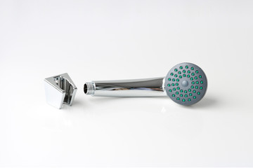 New shiny shower head and wall mount for it. On a light background. Materials for plumbing works.