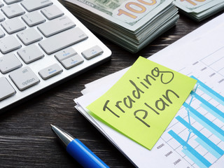 Trading plan concept. A bundle of papers with data on the table.