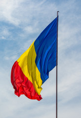 C\low angle shot of Romania flag on a cloudy sky background