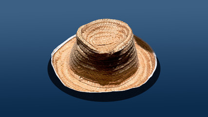 Fototapeta na wymiar straw hat for a farmer with a blue color background.