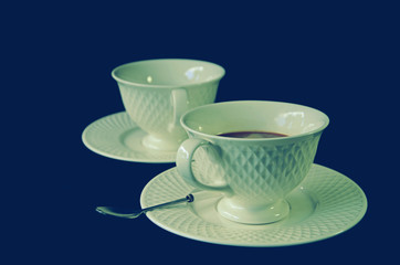 White hot coffee cups on the saucers with black background1