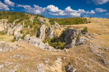Fototapeta na wymiar Aerial view over Dobrogei Gorges road and rock landscape from Constanta, Romania - amazing landmark with blue sky and white clouds