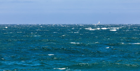 Roman Rock lighthouse in False Bay, Cape Town, on a rough seas day