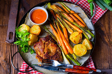 grilled neck chops with caramelized vegetables.