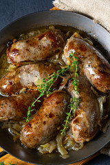 Homemade white sausage fried with onion and herbs