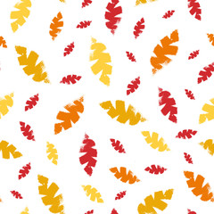 Mono print style scattered leaves seamless vector pattern background. Textured cut out yellow, red, orange foliage on white backdrop. Hand crafted painterly stamp design. For summer or fall products