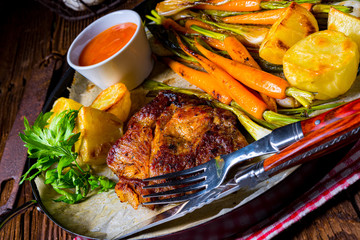 grilled neck chops with caramelized vegetables.