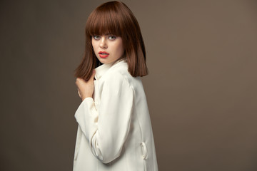 Elegant model in beige jacket gesticulate with hands 