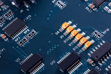 Electronic circuit board with electronic components such as chips close up. Blurry background.	