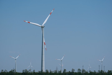 landscape with wind farm on blue sky background