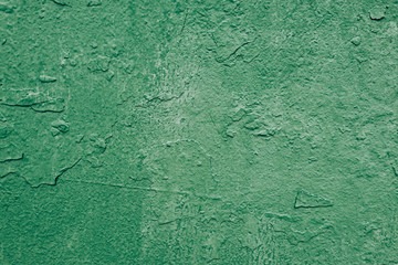 tectured old wall with a faded green paint