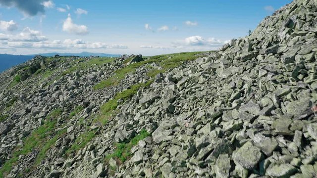 aerial view of mountain landscape with stone peaks and green highland. panorama of Zuratcul national park and Big Suka mountain range. dangerous stone steep slopes of mount. sunny summer day