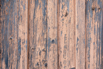 Wooden background of old boards with cracked and peeling paint.