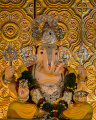 Closeup view of decorated and garlanded Isolated idol of Hindu God Ganesha.
