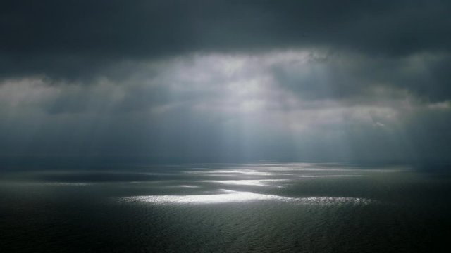 Scenic seascape. Beautiful rays of sun breaking through the clouds over The Black sea. 4K