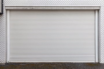 Automatic silver roller shutter doors on the ground floor of the house