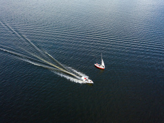 Jet skis sail along the river. Aerial drone view.