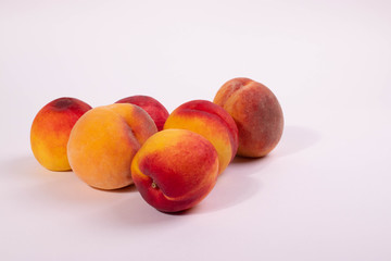 a group of round peaches on the light background