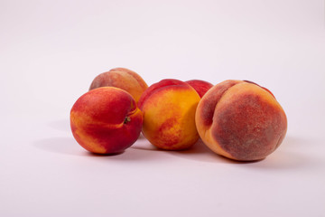 a group of round peaches on the light background