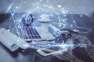 Computer on desktop with social network hologram. Double exposure. Concept of international people connections.