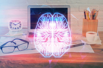 Double exposure of desktop with computer and brain drawing hologram. Artificial intelligence...