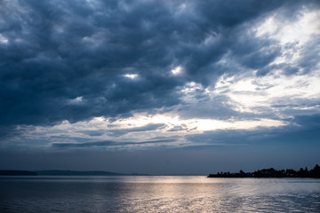 cloudy sky over the sea. the sky after the rain. clouds are reflected in the water. Summer evening in nature. River and reflection. Miserable summer