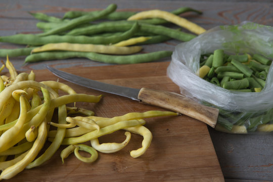 Green beans on wooden cutting board.Cooking green beans for long-term storage in the frezer.