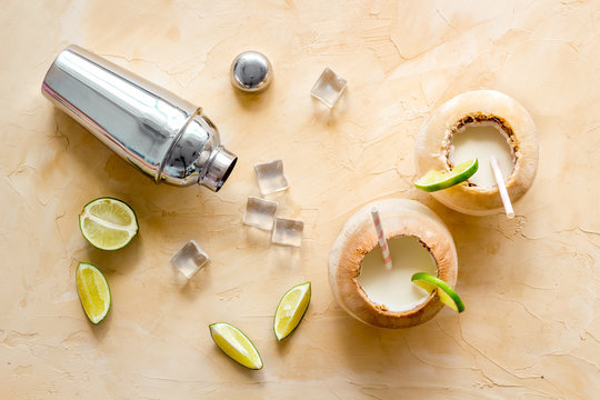 Pina Colada Drink In Coconut With Ice Cubes And Shaker, Top View