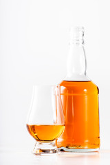 Scotch Whiskey without ice in glasses and bottle, white background, copy space