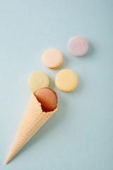 Several colorful macaroon cakes on a colored background