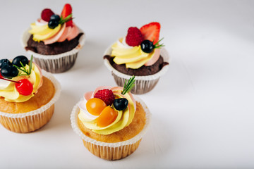 chocolate cupcakes with cream and fresh berries