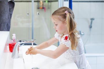 little girl washing hands