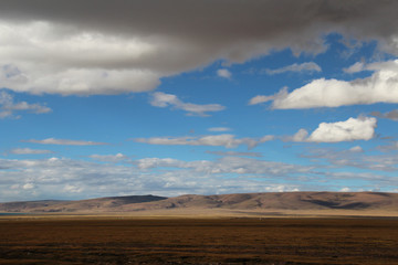 View of mountains with the dramatic sky near Namtso in Tibet, China