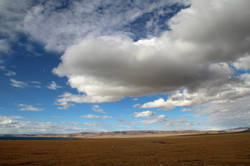 Fototapeta na wymiar View of mountains with the dramatic sky near Namtso in Tibet, China