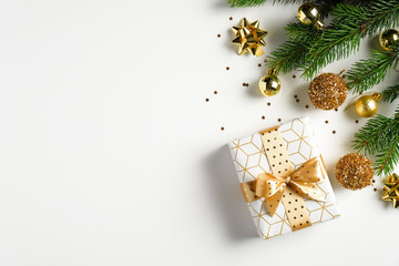 Christmas card mockup. Fir tree branch with golden balls, gift box and confetti on white background...